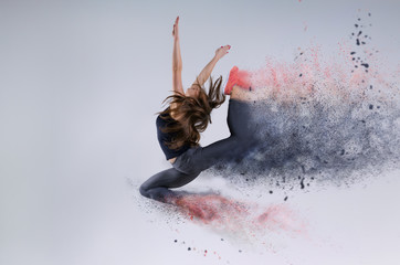 Woman in jump. Frozen motion. Photo manipulation of disintegration - 139273565