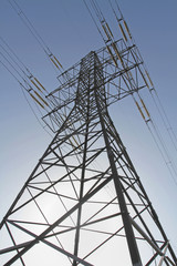 Tower of power line with wires and fuses is oriented upward view from below.