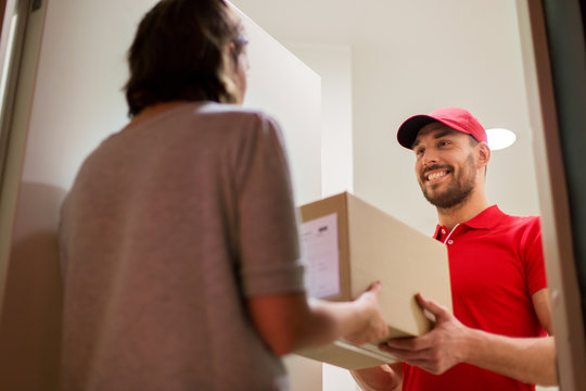 happy delivery man giving parcel box to customer