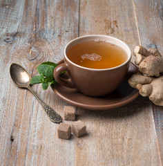 Cup of ginger tea, cubes of brown sugar