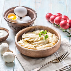 Cooked and served vareniki, vegetables on side