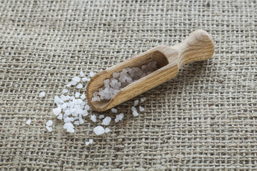 Salt crystals on wooden spoon on canvas
