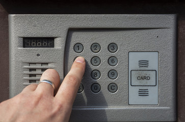 Men's hand presses the button to go