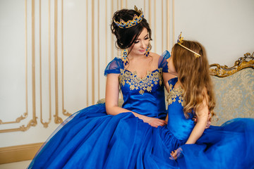 Beautiful princess mother and daughter in a gold crown © MZaitsev