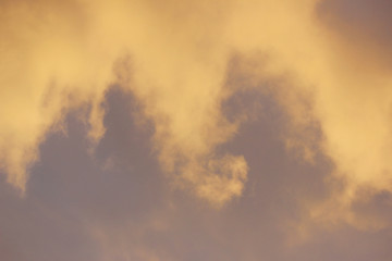 snow cloud painted in gold color of the setting of the spring sun