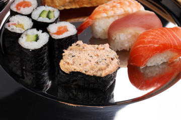 close up of sashimi sushi set with chopsticks and soy - sushi roll with salmon and sushi roll, delicious maki and nigiri