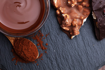 Melting chocolate and diffrent bars - stack and chips with chocolate swirl/ powder and cocoa pod with melted chocolate