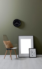 modern metal chair and frames green wall backgorund