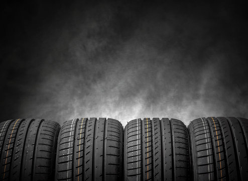 Car tires on a dark background.