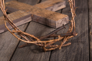 Crown of Thorns and Nails With Wooden Cross in Background