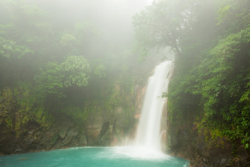 Rio celeste waterfall at foggy day