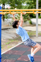 Fototapeta premium Young boy play with yellow bar