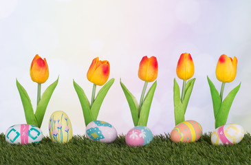 Row of Colorful Easter Eggs and Tulips