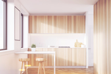 Fototapeta na wymiar Light wood kitchen interior with a table, toned