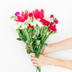 Bouquet with beautiful flowers in female hands isolated on white background. Flat lay, top view