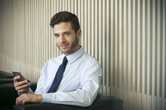 Businessman using smartphone, portrait