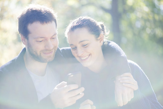 Couple using mobile app on smartphone for navigation