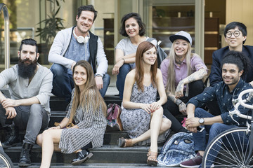 Group of creative colleagues sitting together outdoors