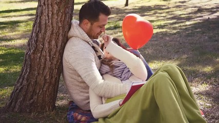 Loving couple reading a book - Powered by Adobe