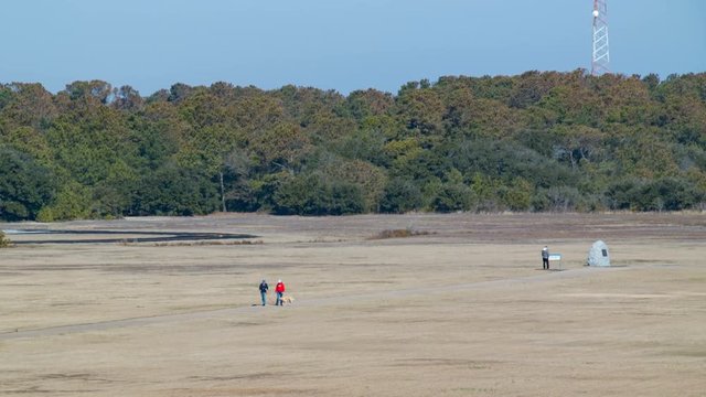 Visitors Walking Along the Wright Brothers Memorial National Park on the Path of the First Flights towards Big Kill Devil Hill in Kitty Hawn North Carolina