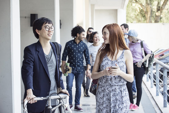 Coworkers chatting as they leave the office