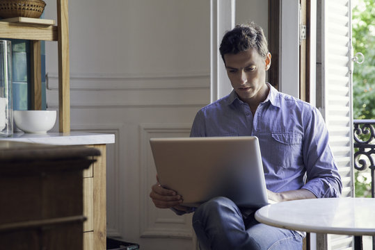 Man using laptop computer at home