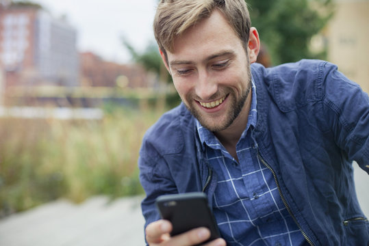 Man text messaging outdoors