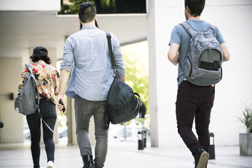 College students walking on campus, rear view
