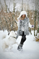 White husky with girl running in snow