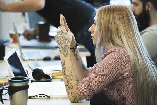 Young woman daydreaming in office
