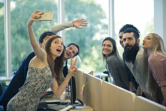 Young adult friends taking group selfie