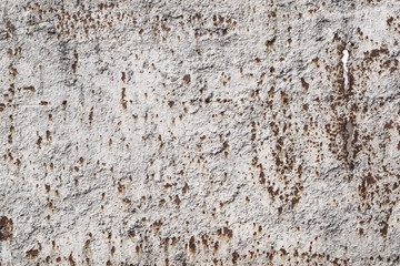 Weathered rusty metal with faded paint and worn texture