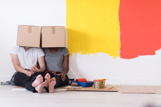 young multiethnic couple playing with cardboard boxes
