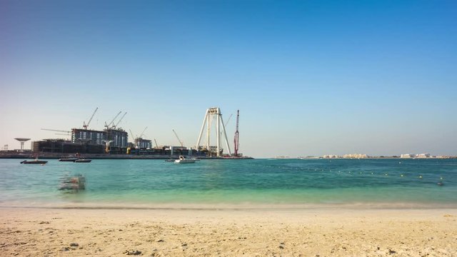 summer day dubai marina beach wheel construction hotel panorama 4k time lapse uae
