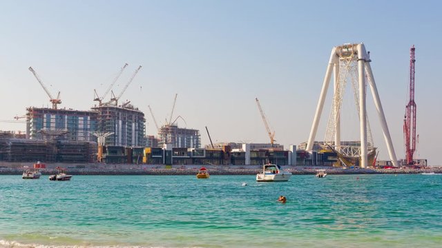 summer day dubai marina bay wheel hotel construction panorama 4k time lapse uae
