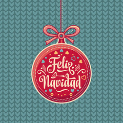 Fototapeta na wymiar Feliz Navidad. Red Christmas ball with good wishes in Spanish. 