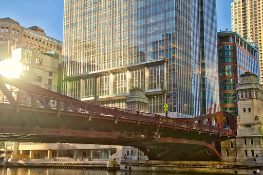 Downtown Chicago Loop Business District during Rush Hour and Sunset, View Looking Up from The Riverwalk to see Lasalle Street Bridge over Chicago River