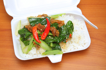 Stir fry chinese broccoli and crispy pork with rice