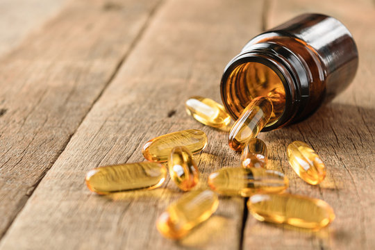 closeup supplements vitamins bottle on wood background