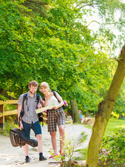 Hiking backpacking couple reading map on trip.