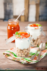 Breakfast in a jar - oat bran, yogurt and jam. Selective focus. Copy space