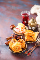 Traditional arabic desserts Kunafa and Baklava with honey and nuts. Selective focus. Copy space.