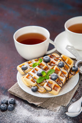 Homemade wafers with berries and tea on a table. Selective focus. Copy space.