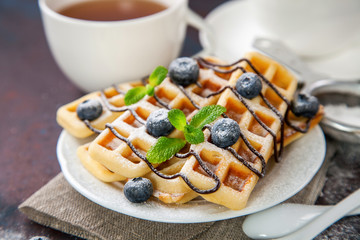 Homemade wafers with berries and tea on a table. Selective focus. Copy space.