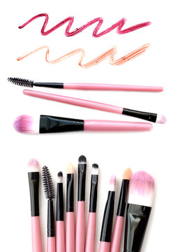Set of pink make-up brushes with lipstick trace isolated on white background.