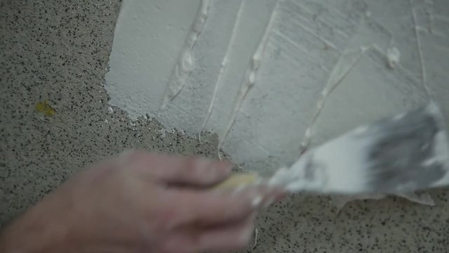 Man Applying Plaster on a Dry Wall. Construction worker plastering