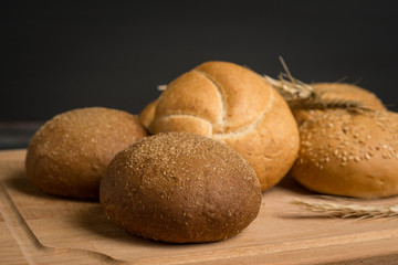 Tasty fresh buns on the wooden background