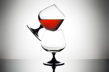 Composition of brandy snifter glass on a white background