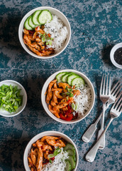 Asian style fried chicken and rice. Delicious lunch on a dark background, top view