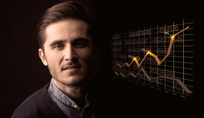 Happy businessman with a growing graph